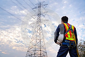 A Technician or Worker holding a safety helmet wear fall arrestor device for worker with hooks for safety body harness. Working at