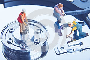 Technician workers repairing hard disk drive. Computer service concept.