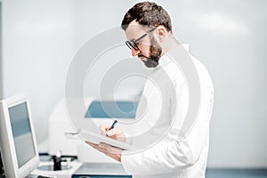 Technician working with analyzer machine