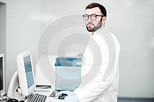Technician working with analyzer machine