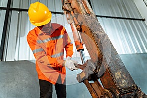 A technician working excavator repair with large iron wrench in a hand, Powerful Professional Mechanic. Heavy Duty Equipment