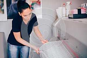 Technician working on plotter and cutter machine in printing centar