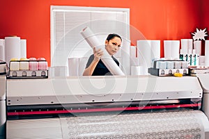 Technician working on plotter and cutter machine in printing centar