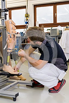 Technician working on prosthetic leg parts