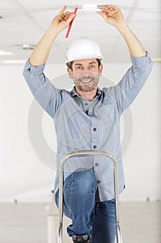 Technician works on ceiling