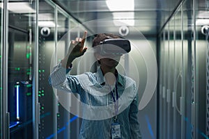Technician works in a data center wearing a VR headset