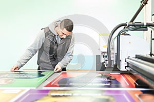 Technician works on large CNC computer numerical control cutting machine photo