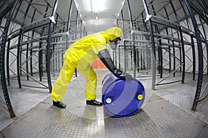 Technician in yellow uniform rolling the barrel wi