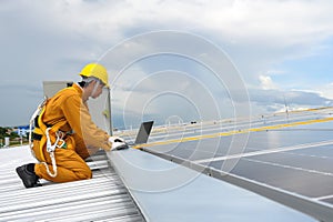 Technician Young Wearing Safety Protective Clothing and Safety Belt to Checking Wiring in Control Panel on Top Roof with Detail in