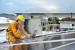 Technician Young Wearing Safety Protective Clothing and Safety Belt to Checking Wiring in Control Panel on Top Roof with Detail in