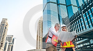 Technicians Caucasian women and man are helping to see the blueprints, Compare with real locations