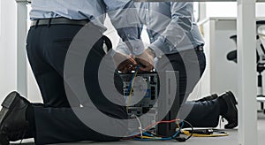 it technicians connecting cables to server tower