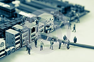 Technicians connecting network cable to motherboard