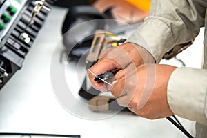 Technicians cutting fiber optic cables.