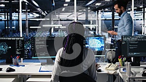 Technicians in data center review AI diagnostics, analyzing neural networks