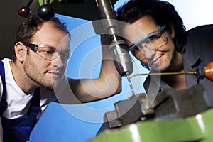 Technicians drilling in workshop