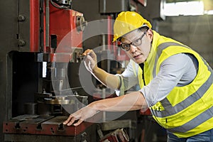 Technicians and engineers are working in a factory with modern machines. Asian man Mechanical Engineer checking equipment in the