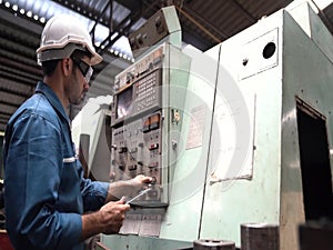 Technicians and engineers are working on machines in a factory. Asian man Mechanical Engineer holding tablet and checking equipmen