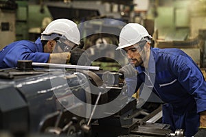 Technicians and engineers are working on machines in a factory. Twins Caucasian man Mechanical Engineer checking equipment in the