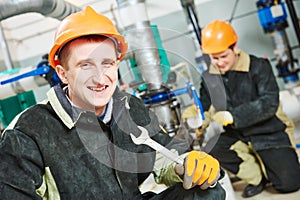 Technicians of heating system in boiler room