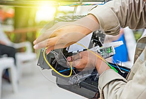 Technicians are install cabinet on fiber optic cable.