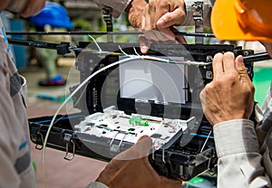 Technicians are install cabinet on fiber optic cable.