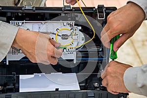 Technicians install cabinet on fiber optic cable.