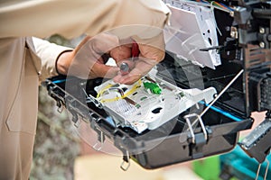 Technicians install cabinet on fiber optic cable.