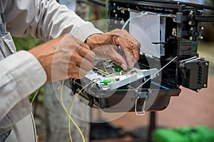 Technicians install cabinet on fiber optic cable.