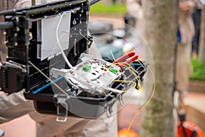 Technicians install cabinet on fiber optic cable.