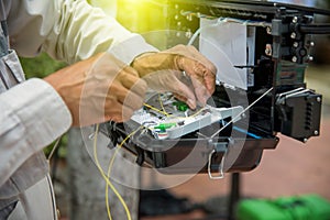 Technicians install cabinet on fiber optic cable.