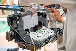 Technicians install cabinet on fiber optic cable.