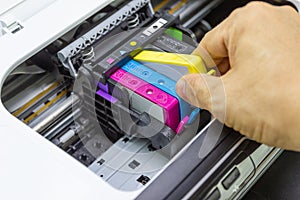 Technicians are install setup the ink cartridge of a inkjet printer the device of office