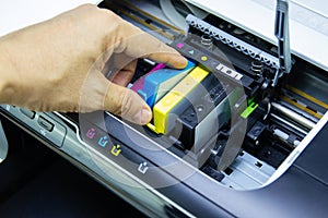 Technicians are install setup the ink cartridge of a inkjet printer the device of office automate