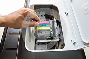 Technicians are install setup the ink cartridge of a inkjet printer the device of office automate