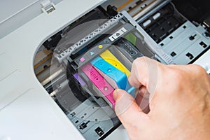 Technicians are install setup the ink cartridge of a inkjet printer the device of office automate