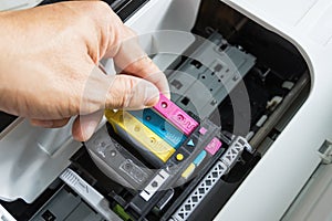 Technicians are install setup the ink cartridge of a inkjet printer the device of office automate