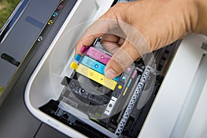 Technicians are install setup the ink cartridge of a inkjet printer the device of office automate