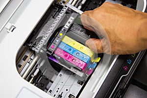 Technicians are installing the color printer inkjet cartridge