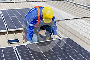 Technicians are installing and inspecting standards of solar panels on roof of an industrial factory. Electrical energy obtained