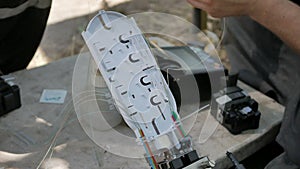 Technicians are installing optic fiber with cable ties.