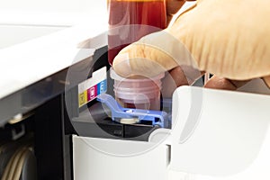 Technicians are installing setup the ink and Insert ink into the fill hole. of an inkjet printer, the device of office automate