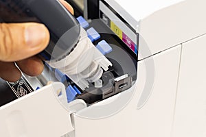 Technicians are installing setup the ink and Insert ink into the fill hole. of an inkjet printer, the device of office automate