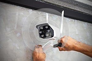 Technicians are installing wireless CCTV cameras