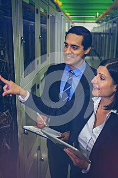 Technicians interacting with each other while analyzing server