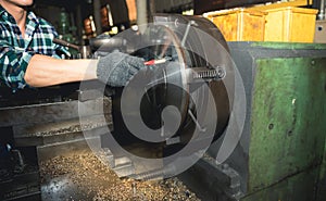 technicians man are working by controlling steel lathes, in parts production line