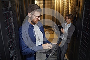 Technicians Managing Server Equipment in Data Center