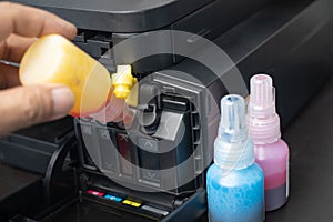Technicians Refill ink cartridges, printer Inkjet colors.Printer Repairs and Maintenance inkjet or Laser printers concept