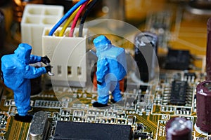 Technicians repair on computer mainboard.