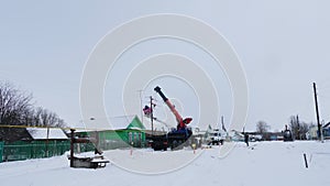 Technicians repair power lines in village on winter day